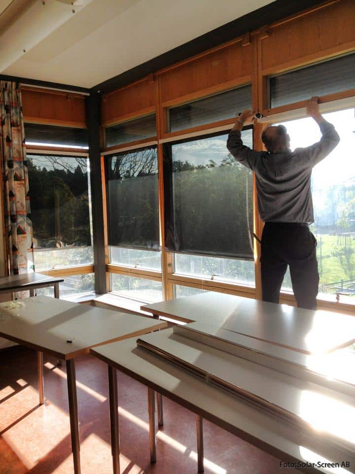 Room with solar roller blinds
