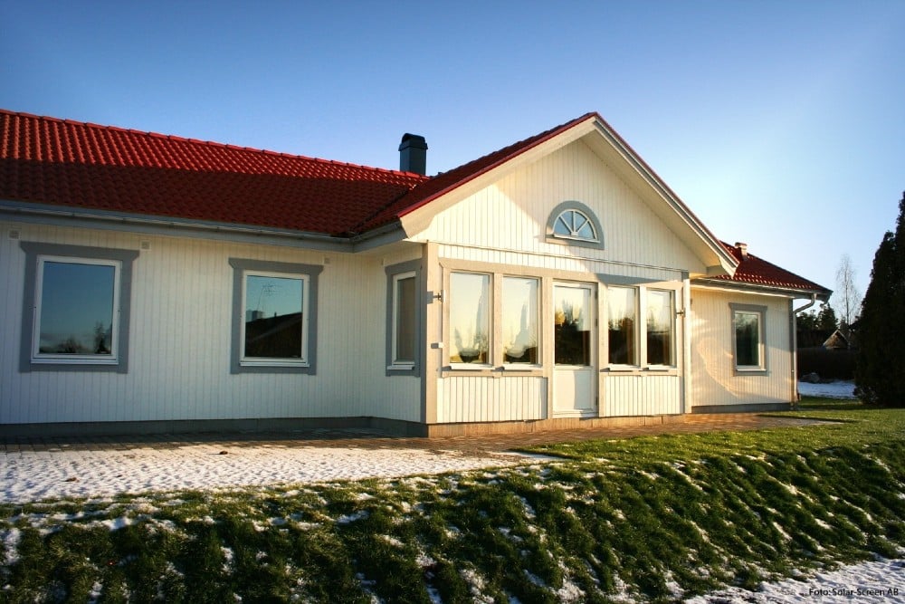 House with solar roller blinds